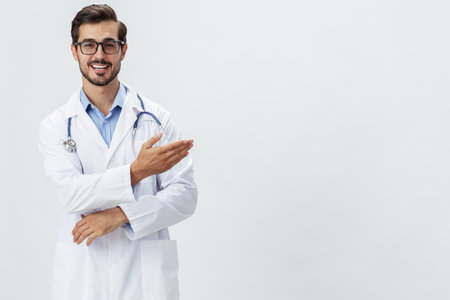 Man doctor in white coat and eyeglasses smile shows hand gestures signs on white isolated background looks into camera, copy space, space for text, healthの写真素材