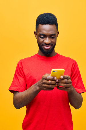 man black mobile yellow background showing phone portrait technology african happy young