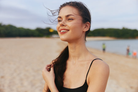 woman sea summer sunset vacation ocean beach sand nature smile lifestyleの写真素材