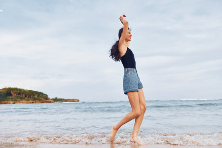 woman summer travel hair sunset beach running lifestyle smile sea youngの写真素材