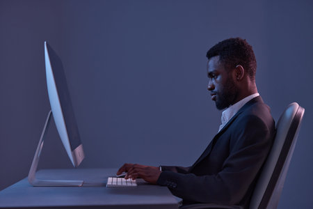 african man lifestyle online business keyboard work technology freelancer american night computerの写真素材