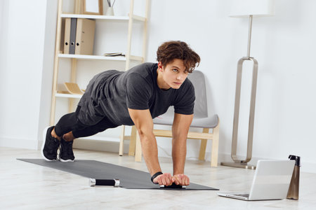 home man dumbbells lifestyle health sport exercise activity training gray indoorの写真素材