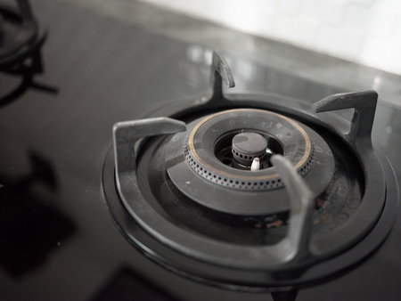 Modern gas stove built into a black table in the kitchen.の写真素材