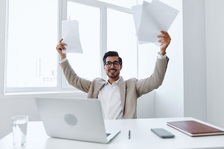 Planning holding laptop paper businessman officeの写真素材