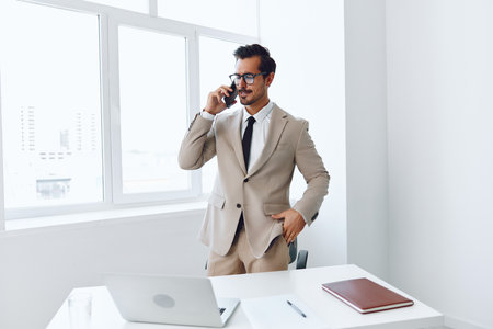 Call man laptop video winner connection glasses businessman computer phone office caucasian talk entrepreneur smileの写真素材