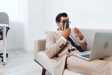 Man phone call lifestyle smile computer laptop talk businessman phone office winner video mobile workplaceの写真素材