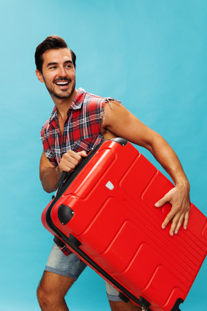 Man background studio flight baggage traveler trip journey happy vacation suitcase travel weekend guyの写真素材