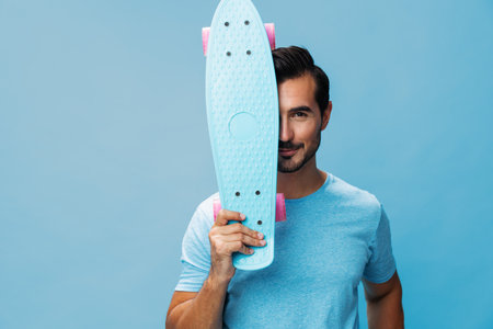 Man skateboard summer skater lifestyle guy space copy blue sport hipster portrait studio skate activeの写真素材