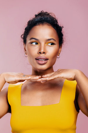 Colourful woman beautiful smile beauty cosmetic african style make-up portrait yellow face creative...
