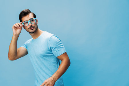 Beard man portrait lifestyle t-shirt style fashion blue background smile trendy glasses modern attractive smartの写真素材