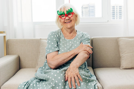 Christmas woman grandmother couch home elderlyの写真素材