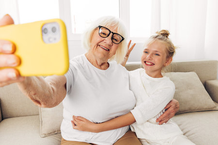 Child bonding selfie family grandmother phone huggingの写真素材