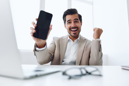 Man office phone businessman smile computer happy talk laptop winner caucasianの写真素材