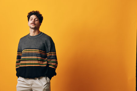 Male man portrait smile happy sweater person student winter orange fashion background trendy confidentの写真素材