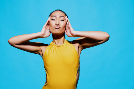 Woman fashion smile blue portrait one trendy lifestyle yellow surprised beautyの写真素材