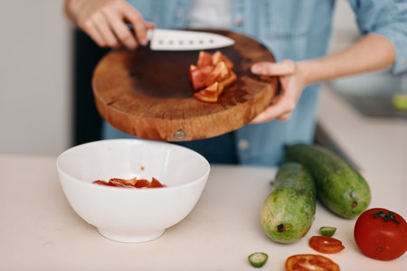 Fresh Kitchen: A Womans Healthy & Vibrant Culinary Exploration Amidst Organic Vegetables, Cutting with Precision.の写真素材