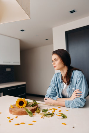 Morning Beauty: Pretty Young Lady Sitting at the Kitchen Table, Enjoying Healthy Breakfastの写真素材