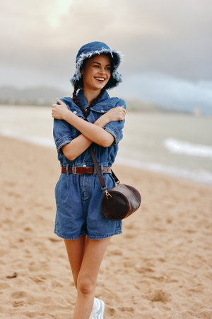 Beach Beauty: Young Womens Summer Lifestyle, Traveling in Fashion with a Hat - A Portrait of a Stylish Asian Lady Enjoying Sunny Holidays on a Tropical Beachの写真素材