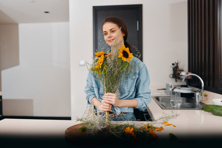 Floral Beauty: A Pretty Woman Holding a Colorful Bouquet in a Blooming Gardenの写真素材