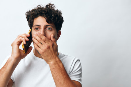 Portrait man online lifestyle connection message phone white smartphone casual t-shirt technology caucasian hipsterの写真素材