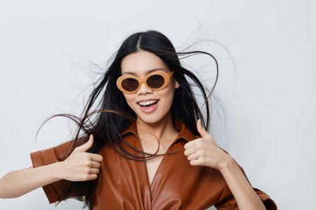 Model woman cosmetic sunglasses vacations asian beauty portrait lifestyle glamour beige fashion...