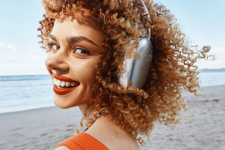 Carefree Summer Vibes: Smiling Woman Enjoying the Beach, Embracing Natures Freedomの写真素材