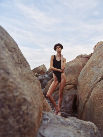 Sun-Kissed Paradise: Attractive Woman Posing in Sexy Swimwear, Enjoying a Happy Summer Vacation on the Beachの写真素材