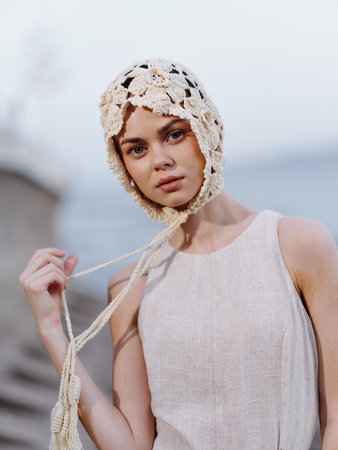 Stylish young lady with attractive face and trendy hairstyle, posing in a black summer dress in a modern urban park.の写真素材