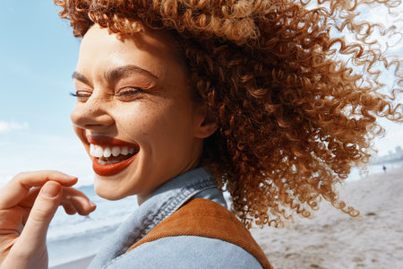 Smiling Womans Happy Beach Vacation Adventure: Joyful Freedom in Natureの写真素材