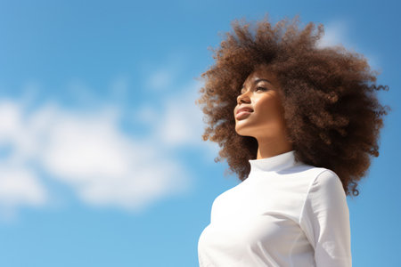 Happy African American Lady with a Beautiful Smile, Laughing and Looking Away, against a Green Wall with Copy Spaceの素材