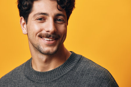 Sweater man fashion yellow background trendy stylish orange posing standing student happy head portrait smileの写真素材