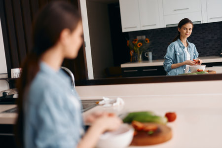 Female Friends Cooking Healthy Breakfast together in Beautiful Kitchenの写真素材