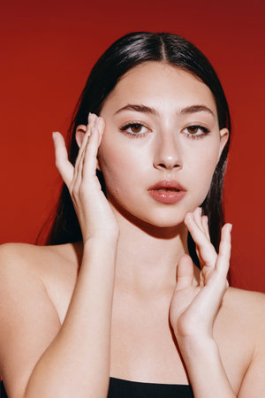 Beauty in Portrait: Young Asian Woman with Clean, Healthy Skin and Natural Makeup, Looking Attractively Glamorous in Studio Backgroundの写真素材