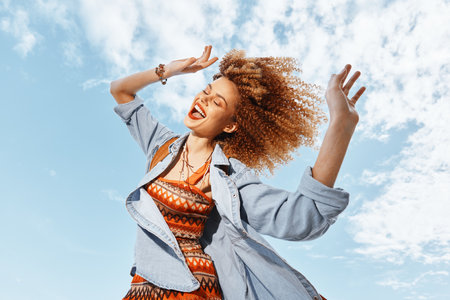 Happy Smiling Woman Dancing on the Beach, Enjoying the Freedom and Beauty of Natureの写真素材