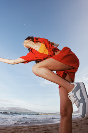 Smiling Woman Dancing with Joy at the Sunny Beach