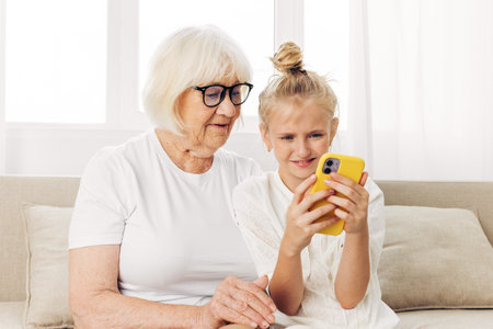 Selfie phone hugging family bonding child grandmotherの写真素材