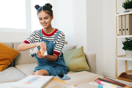 Creative Teenage Artist Enjoying Painting in a Modern Indoor Studioの写真素材
