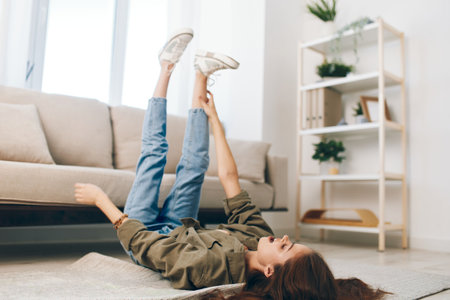 Comfortable Living: Woman Relaxing on a Cosy Sofa in Modern Apartmentの写真素材
