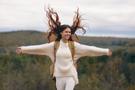 Mountain Adventure: Smiling Woman on Cliff, Backpacking in Springtimeの写真素材