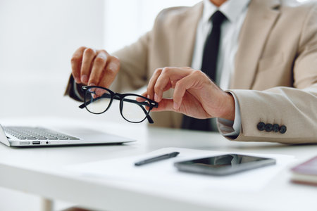 Suit man businessman pen hold corporate write hands business concept document desk looking planの写真素材