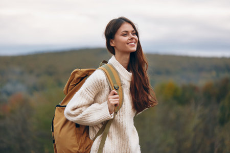 Smiling Woman on an Adventure: Mountain Cliff Hiking in Springtimeの写真素材