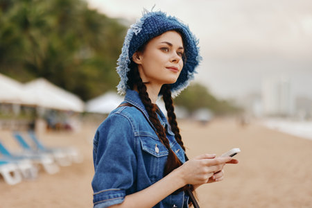 Stylish Young Woman with Pretty Hair, Relaxing Outdoors in the City Park, Embracing Natures Beauty.の写真素材