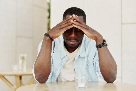 Problem man african male young pain sitting person stress sad black unhappy adultの写真素材