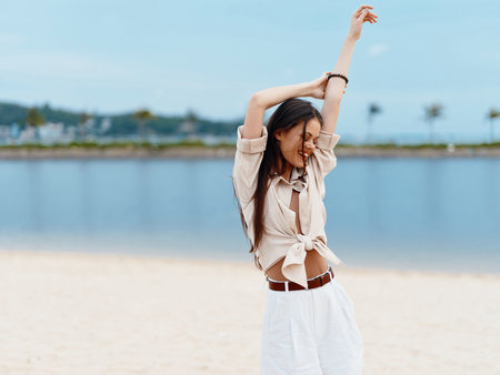 Sun-Kissed Serenity: A Delightful Beach Escape with a Beautiful Young Woman Embracing the Tranquil Seaの写真素材