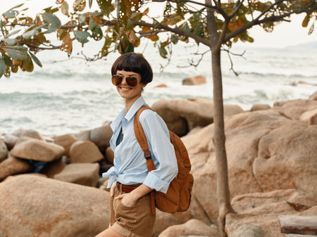 Carefree Traveler: Happy Woman Walking Along the Tropical Beach, Enjoying Sunset Adventureの写真素材