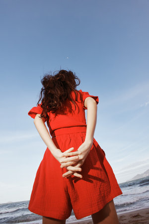 Smiling Woman Dancing with Joy, Enjoying the Sunny Beach"の写真素材