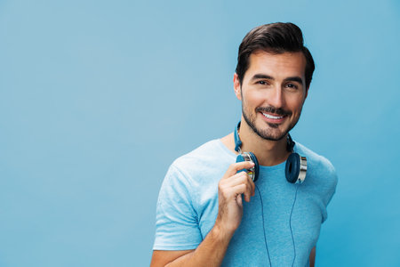 Man studio online headphone sing space fun music t-shirt portrait copy blue happy lifestyle