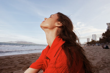 Sunset Serenity: A Beautiful Woman Enjoying a Carefree Beach Vacation with Sensuality and Happiness...