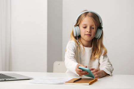 Smiling girl doing elearning at home with laptop modern education in a virtual classroom