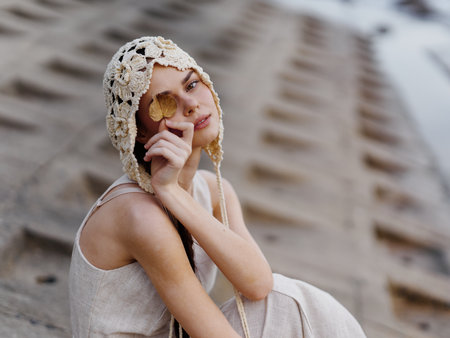 Stylish Lady: A Young Caucasian Woman in a Red Dress, Posing with Elegance and Gracefulness against a Vintage Urban Backgroundの写真素材